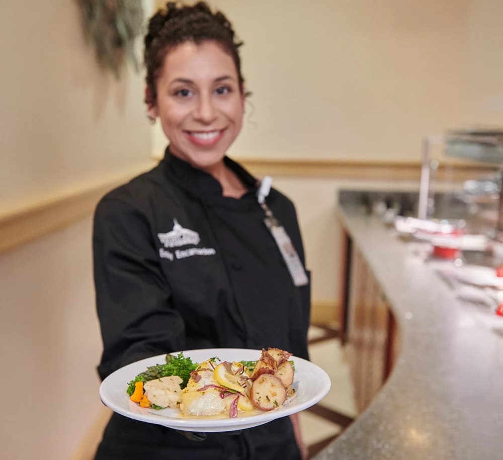 Woman holding plate of food