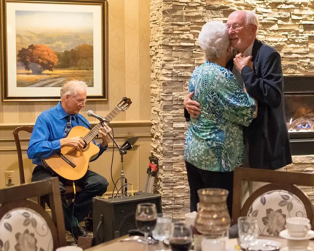 Man and woman dancing to live music