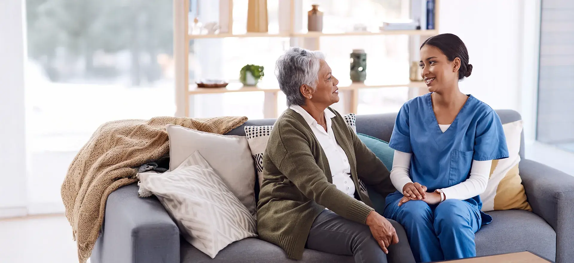 Woman and care giver on couch