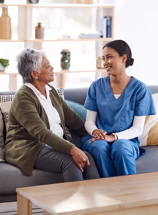Woman and care giver on couch
